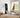 Woman doing yoga with the best all-in-one home gym in a bright bedroom