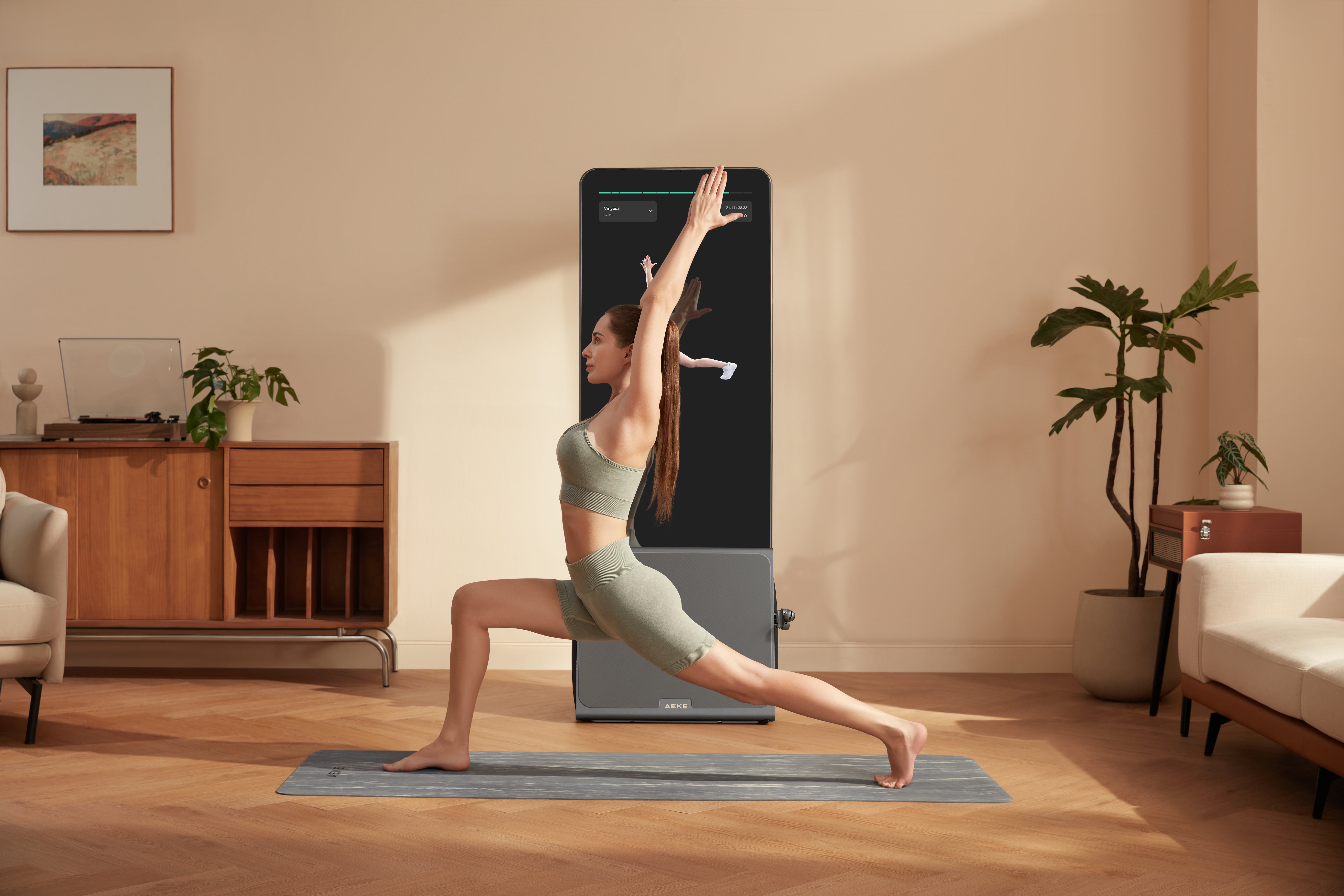 Woman holds a high lunge on a mat beside a fitness display showing a similar pose.
