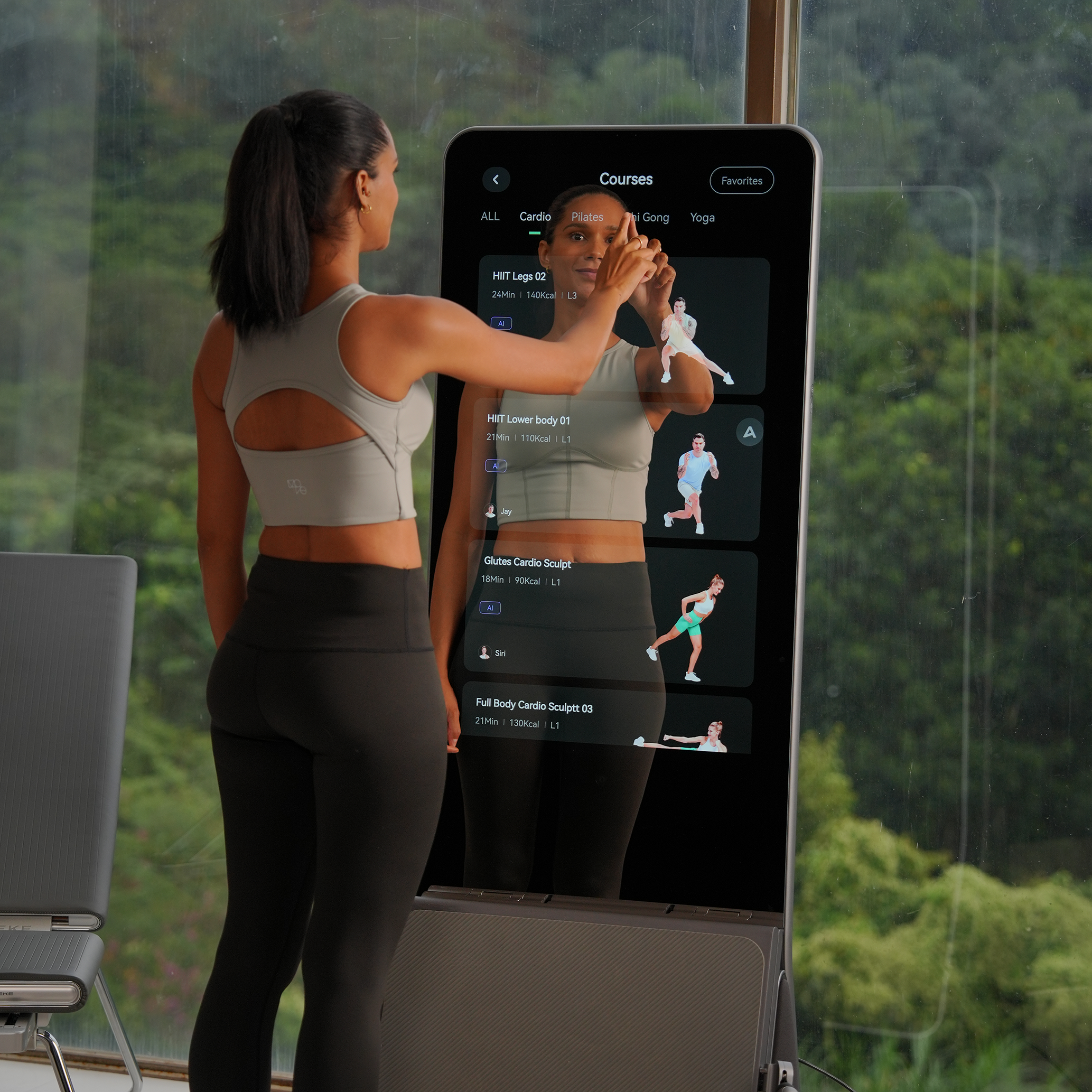 A woman interacting with a touch-screen workout mirror to select a fitness program.
