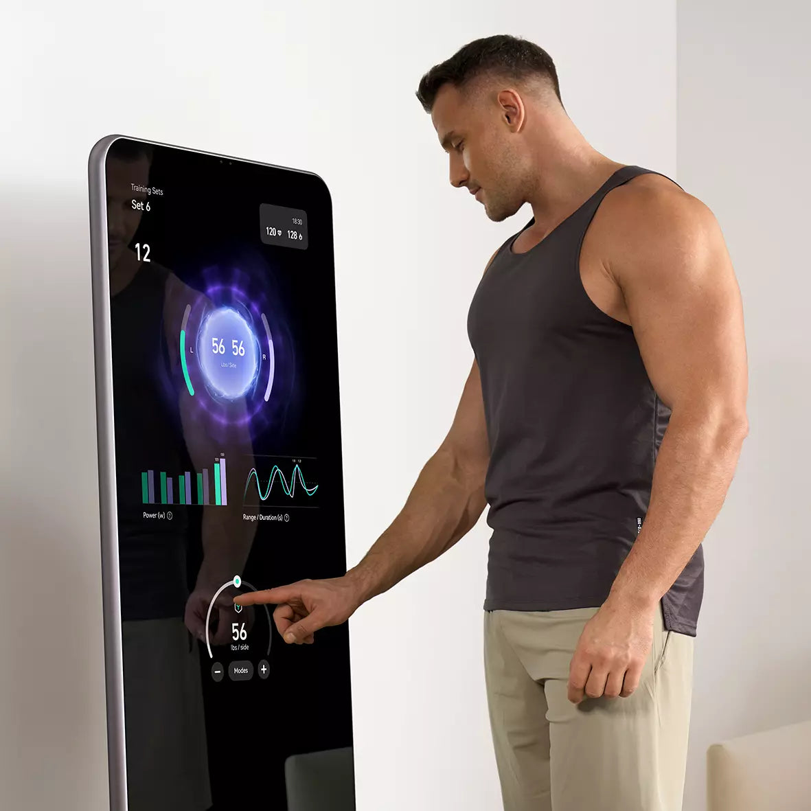 A man interacting with the touchscreen interface of a smart fitness mirror to track his workout data.