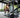 Woman performs a cable squat on a digital resistance training machine.
