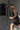 Man performing a standing cable exercise while gripping a rope attachment with both hands.