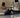 Woman exercising with a cable machine while seated on the floor
