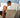 Man performing a squat workout in front of the AEKE K1 smart home gym mirror