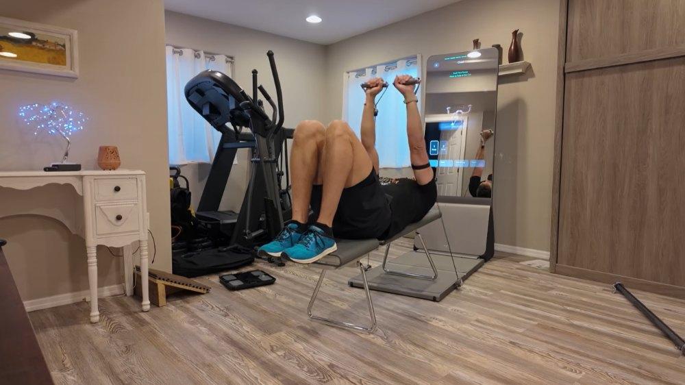 Man performing bench press exercise with AEKE Smart Home Gym K1 resistance bands