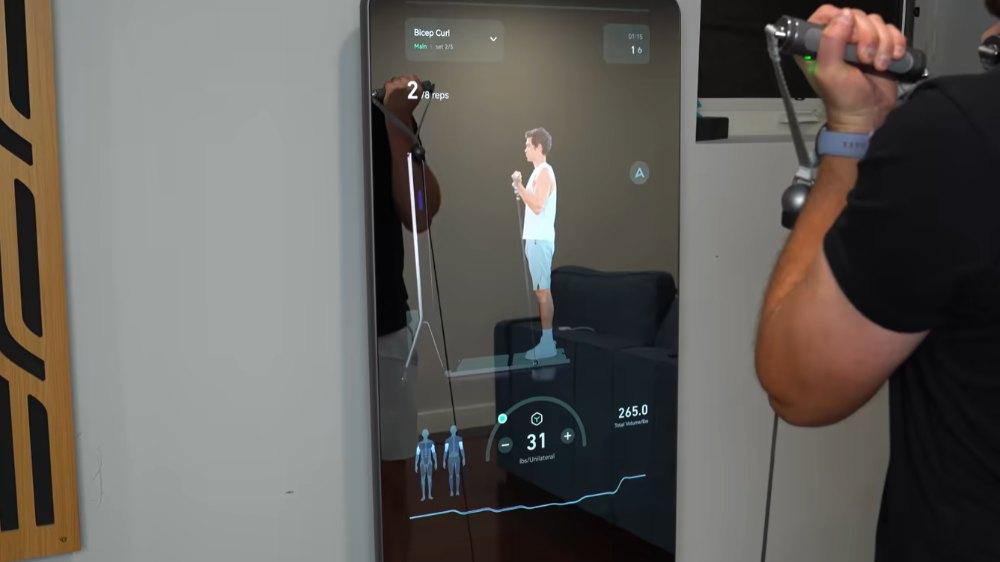 Person performs bicep curls using AEKE K1 smart trainer mirror with workout guidance