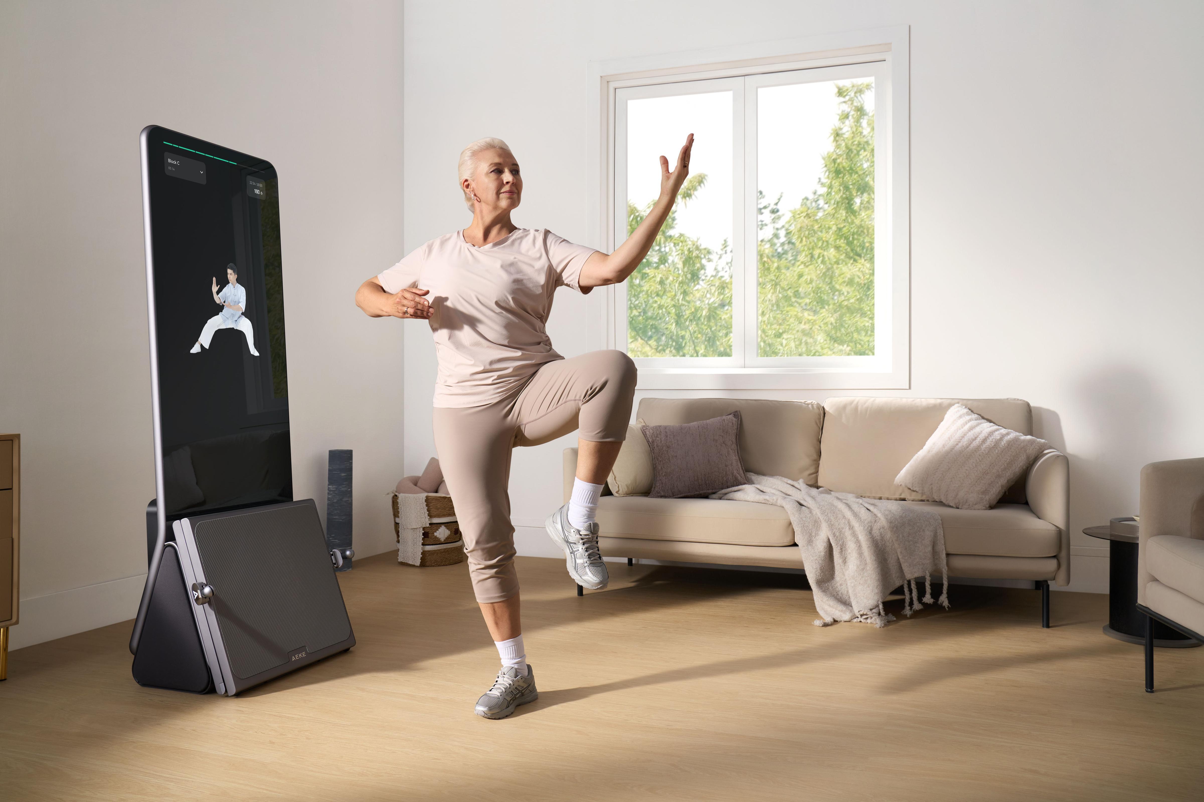 Senior woman using smart home gym for guided workout