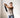 Man using AEKE strength equipment in front of home workout room mirrors, focusing on smart fitness and cable rows