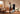 Athlete stretching in home gym, guided by smart fitness mirror screen